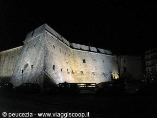 Illuminated bastion of Bari castle at night, massive stone walls