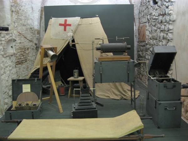 Field hospital tent with red cross and vintage military X-ray equipment