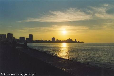 Havana's Malecón at low sun, skyline across the bay, seaside promenade silhouetted