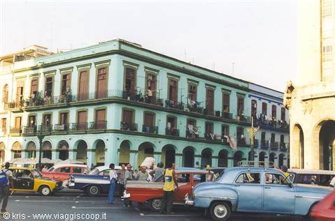Sea-green colonial building with vintage cars, Havana