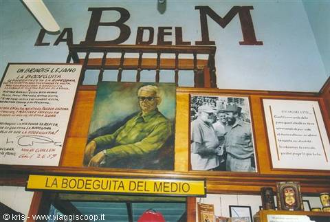 Hemingway portrait and vintage photos inside La Bodeguita del Medio, Havana