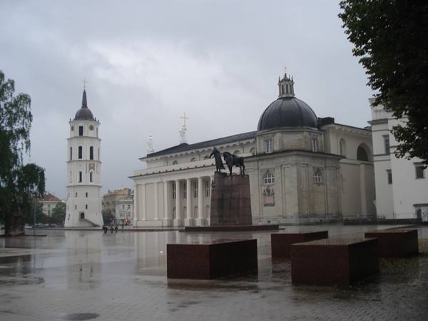Vilnius Cathedral Square with bell tower, dome and equestrian statue under rain