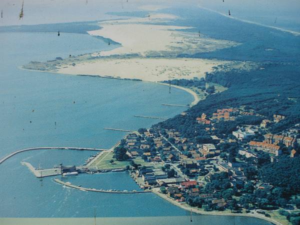 Aerial view of seaside resort with harbor and sandy beaches