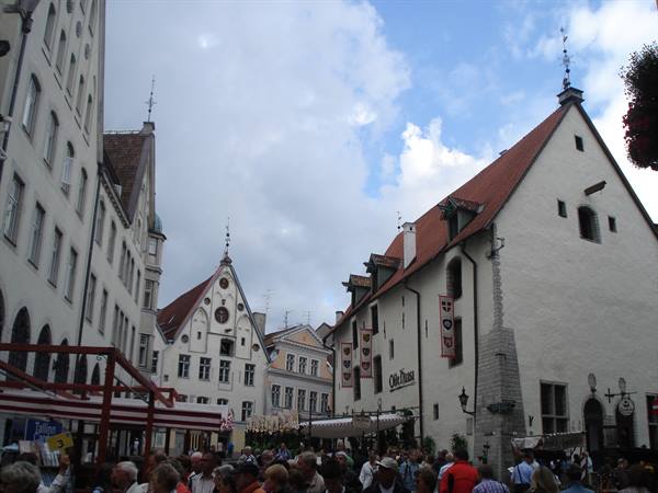Crowd at Tallinn Town Hall square, old guild houses with red roofs