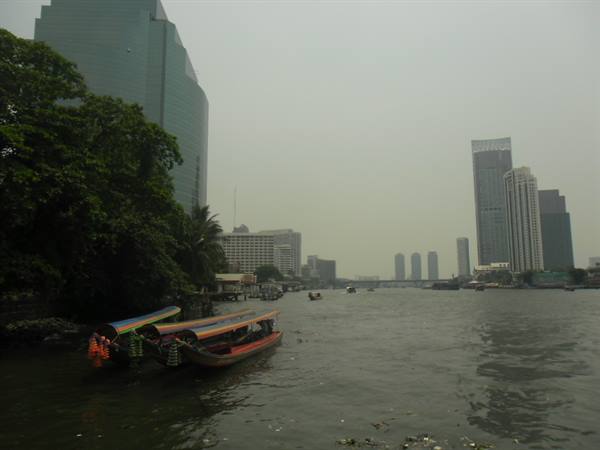 skyscrapers and boats along the Chao Praya in Bangkok