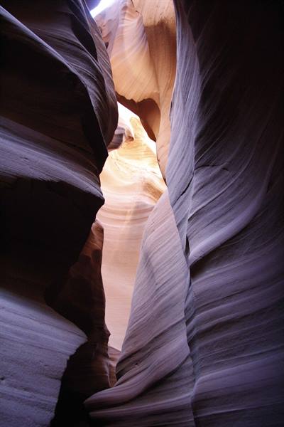 Wavy sandstone walls in Antelope Canyon, sunlight streaming from above