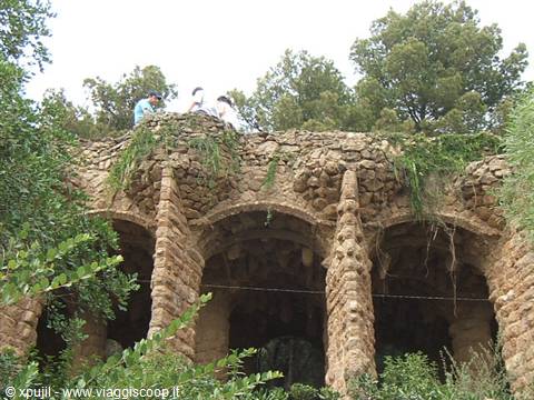 Tourists on Gaudí's stone viaduct at Park Güell, Barcelona