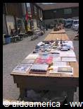 Wooden tables with secondhand items for sale at a flea market