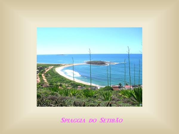Setibão beach with pale sand, green headland and agaves, blue sea
