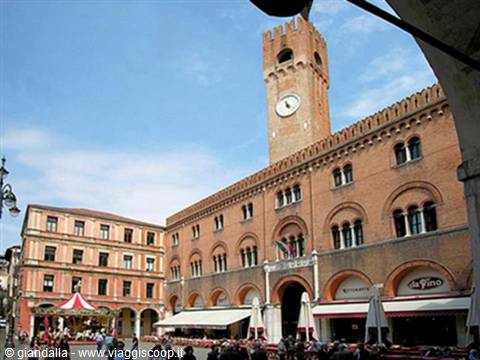 Piazza dei Signori in Treviso with brick civic tower and outdoor cafés