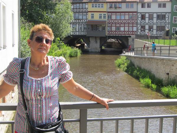 Woman with sunglasses on the Krämerbrücke wooden bridge over the Gera river, Erfurt