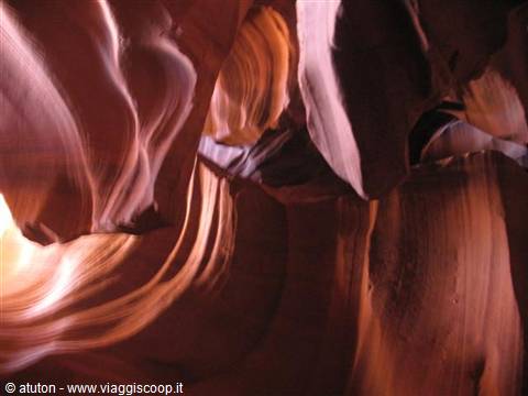 Antelope Canyon, wind-sculpted sandstone, golden waves under raking light