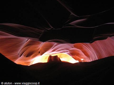 Antelope Canyon: wavy sandstone walls glowing with orange light