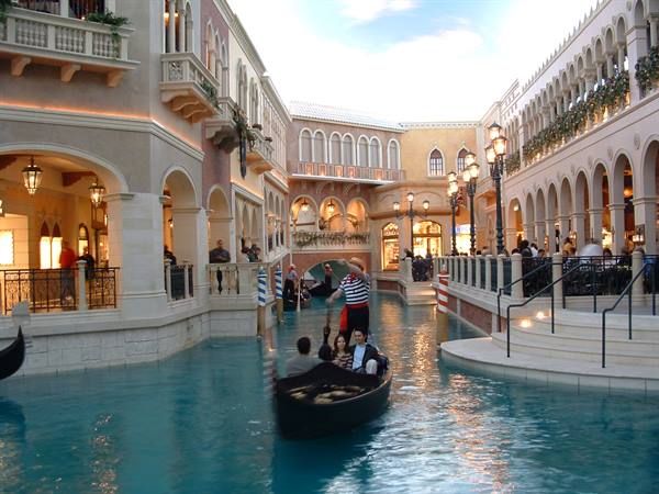 Gondolier rows tourists in a gondola along the Venetian's indoor canal