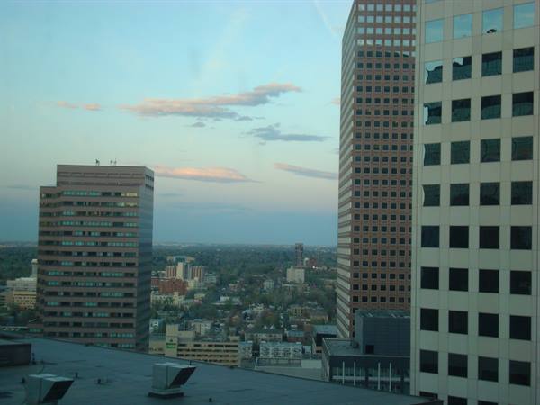 Brick skyscrapers rising over the city, pale sky with pink clouds