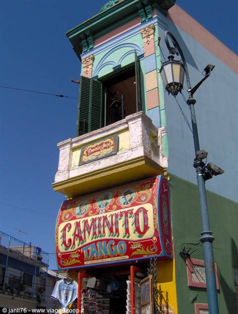 Colorful Caminito Tango sign on multicolored building, street lamp, blue sky, Buenos Aires