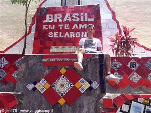 Tourist sitting on the Selarón Steps, red tile mosaic in Rio de Janeiro