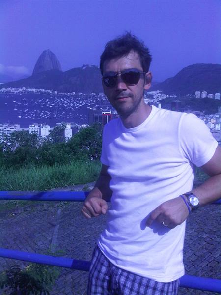 Man in sunglasses and white t-shirt in front of Sugarloaf Mountain, Rio de Janeiro