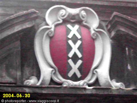 Amsterdam coat of arms with three Saint Andrew's crosses carved in white stone