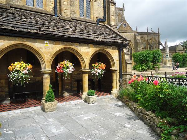 a view of the Alm Houses and in the background the cathedral of Sherborne, Dorset