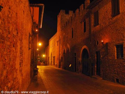 Castles and medieval villages in Tuscany, Certaldo Alto (FI) Via Boccaccio with lit medieval torches