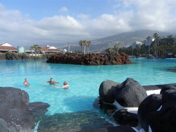 Someone is swimming in the, to me, freezing pool waters!