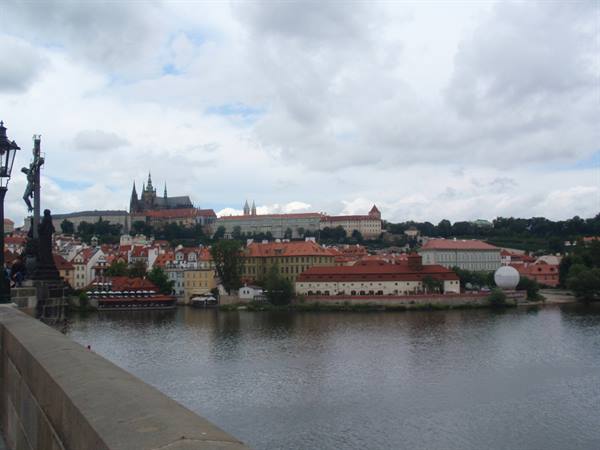 From Charles Bridge, Prague Castle and the Vltava under grey clouds