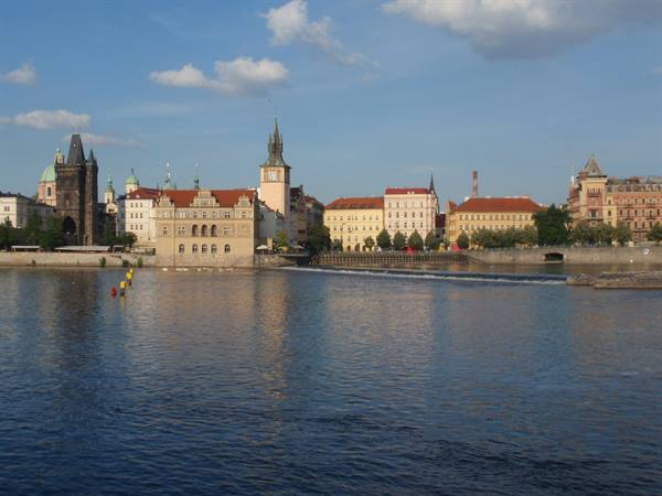 Vltava river with historic buildings and Gothic tower, Prague