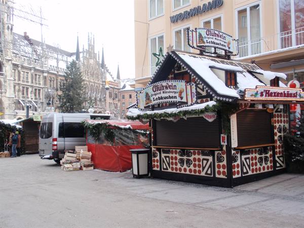 Snow-covered Christmas market stall selling Glühwein and Lebkuchen at Munich's Marienplatz