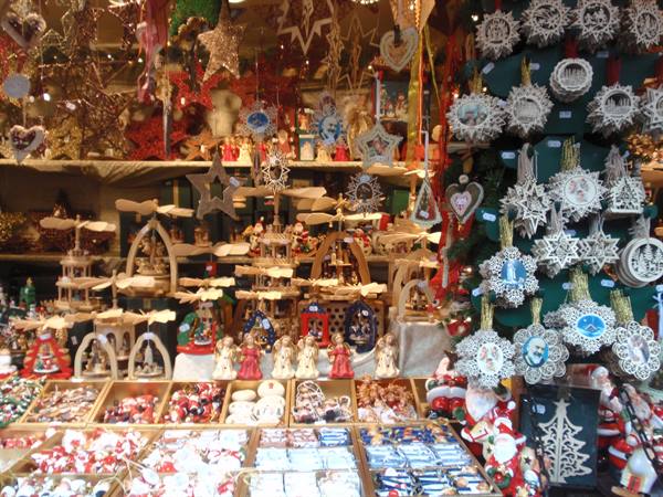 Christmas market stall with wooden pyramids, ornaments and festive decorations