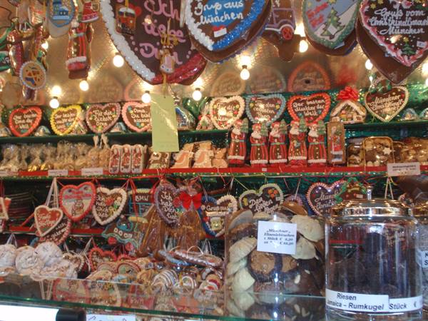 Christmas market stall with gingerbread, decorated hearts and jars of sweets