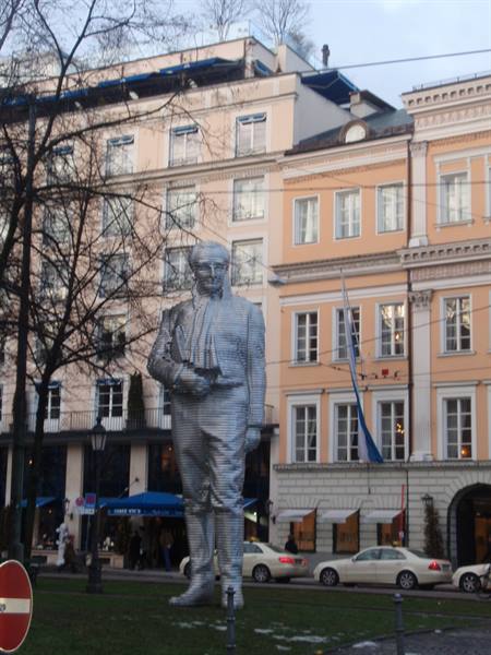 Metal Mozart statue among pastel buildings in Salzburg