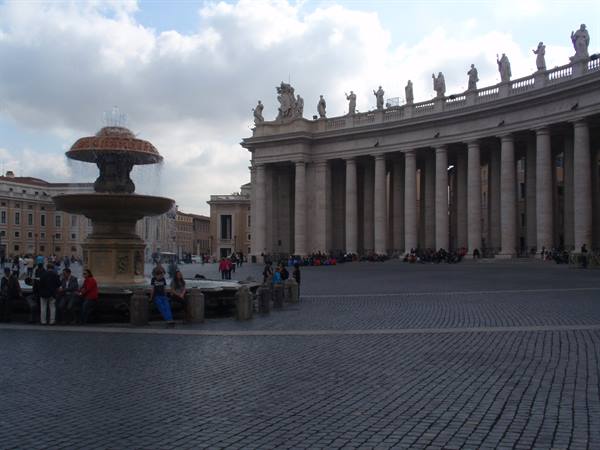 St Peter's Square in Rome, baroque fountain and Bernini colonnade under clouds