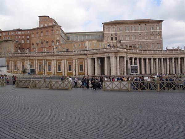 Tourists gathered by Bernini's colonnade in St. Peter's Square, Vatican