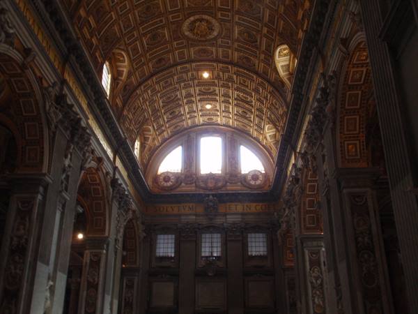 Gilded coffered ceiling over the nave of St. Peter's Basilica, daylight through windows