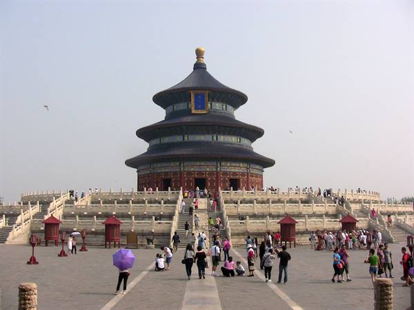Tourists in front of the Temple of Heaven in Beijing, overcast sky