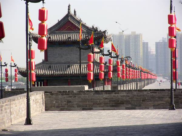 Xi'an city wall: gray brick tower among red lanterns and skyscrapers