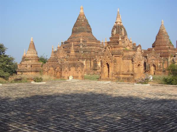 Brick temples with spires in Bagan under blue sky