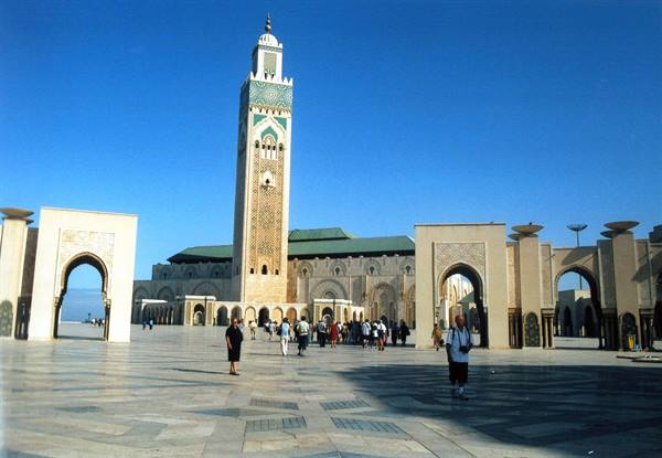 Visitors walk across the marble esplanade of Hassan II Mosque in Casablanca