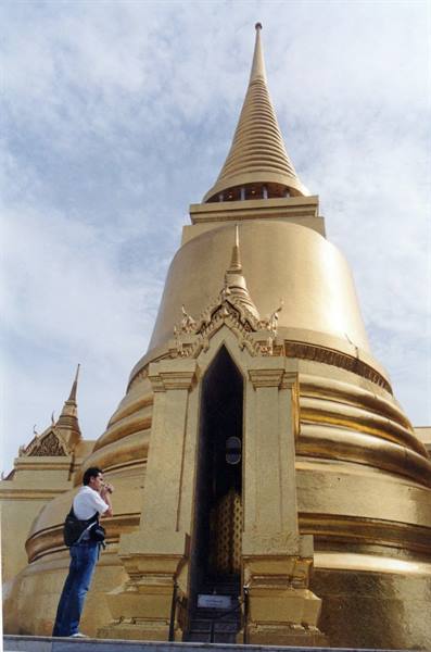 Tourist photographs the golden stupa of Wat Phra Kaew, Bangkok