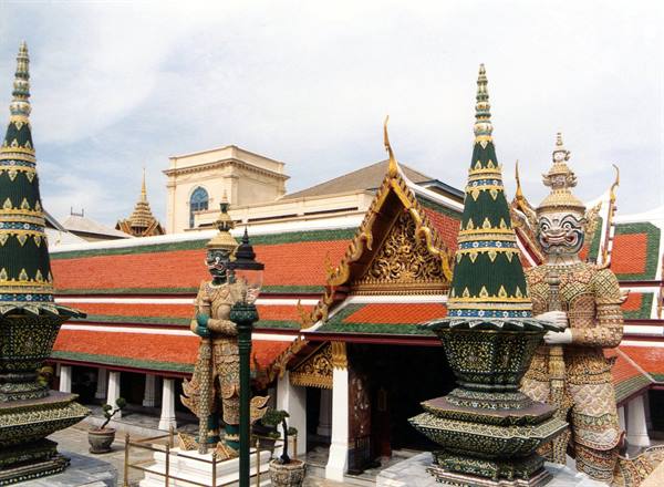Demon guardian statues and gilded stupas at Wat Phra Kaew
