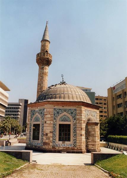 Konak Yalı Mosque in Izmir, tiled dome and stone minaret among modern buildings