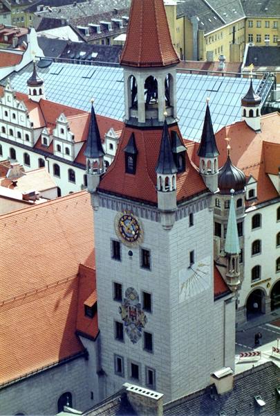 Old Town Hall tower in Munich with clock, red roofs and bell chamber