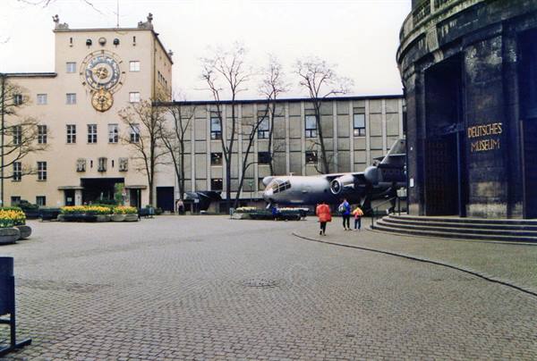 Aircraft displayed in the Deutsches Museum courtyard under a grey sky
