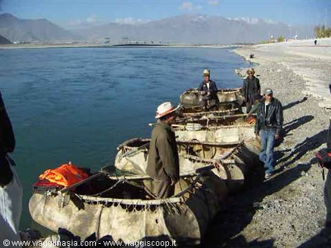 Yak-hide coracles moored on the Tsangpo gravel bank, mountains behind