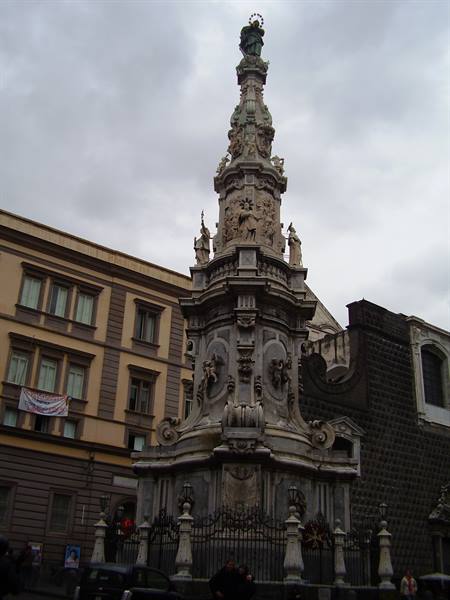 The marble Immacolata spire in Piazza del Gesù Nuovo, Naples, grey sky