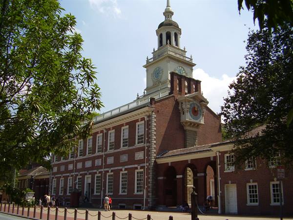 Independence Hall in Philadelphia: red brick, clock tower, tourists in sunlight