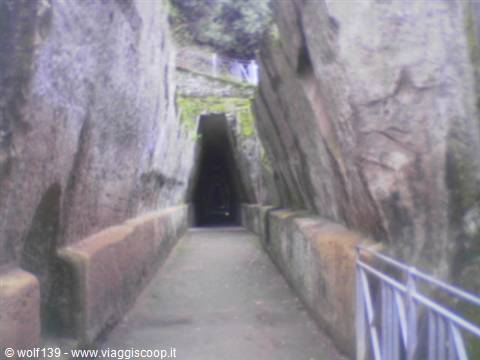 Triangular entrance carved into rock: the Sibyl's Cave at Cumae