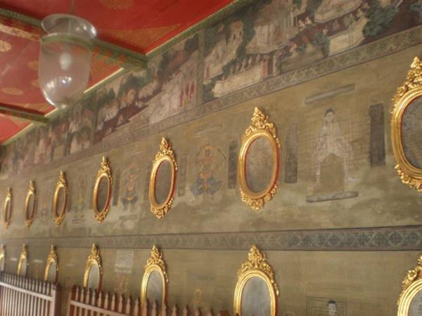 Ancient murals with golden oval frames inside Wat Pho temple, Bangkok