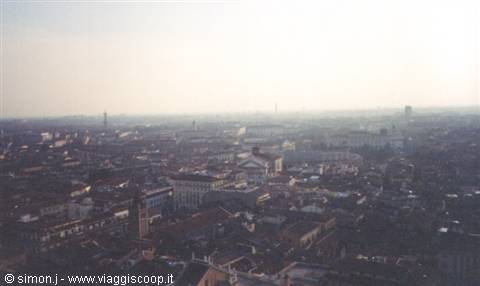 rooftops and bell towers under haze seen from above